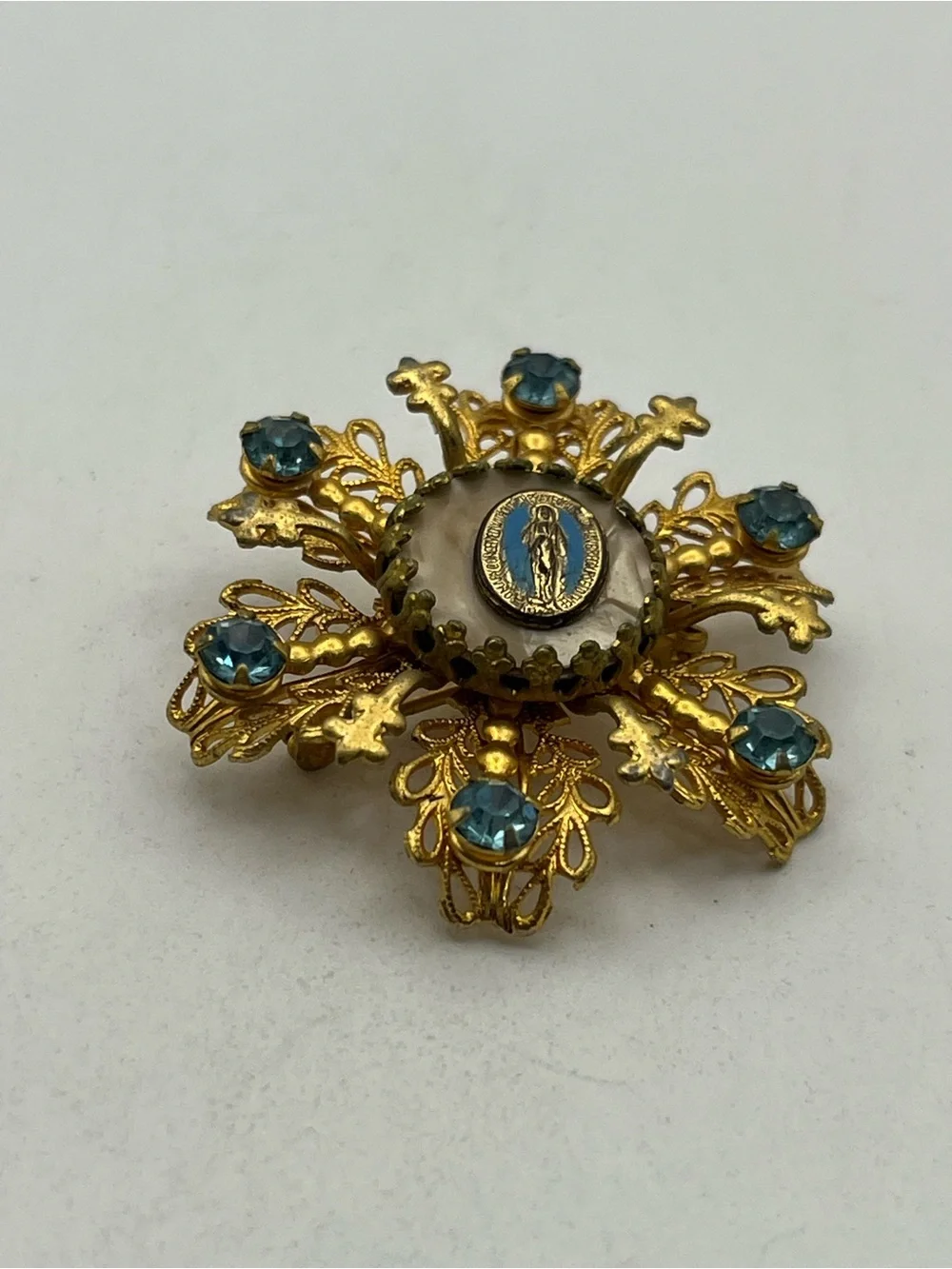 Miraculous medal Catholic Virgin Mary blue rhinestone gold tone starburst brooch